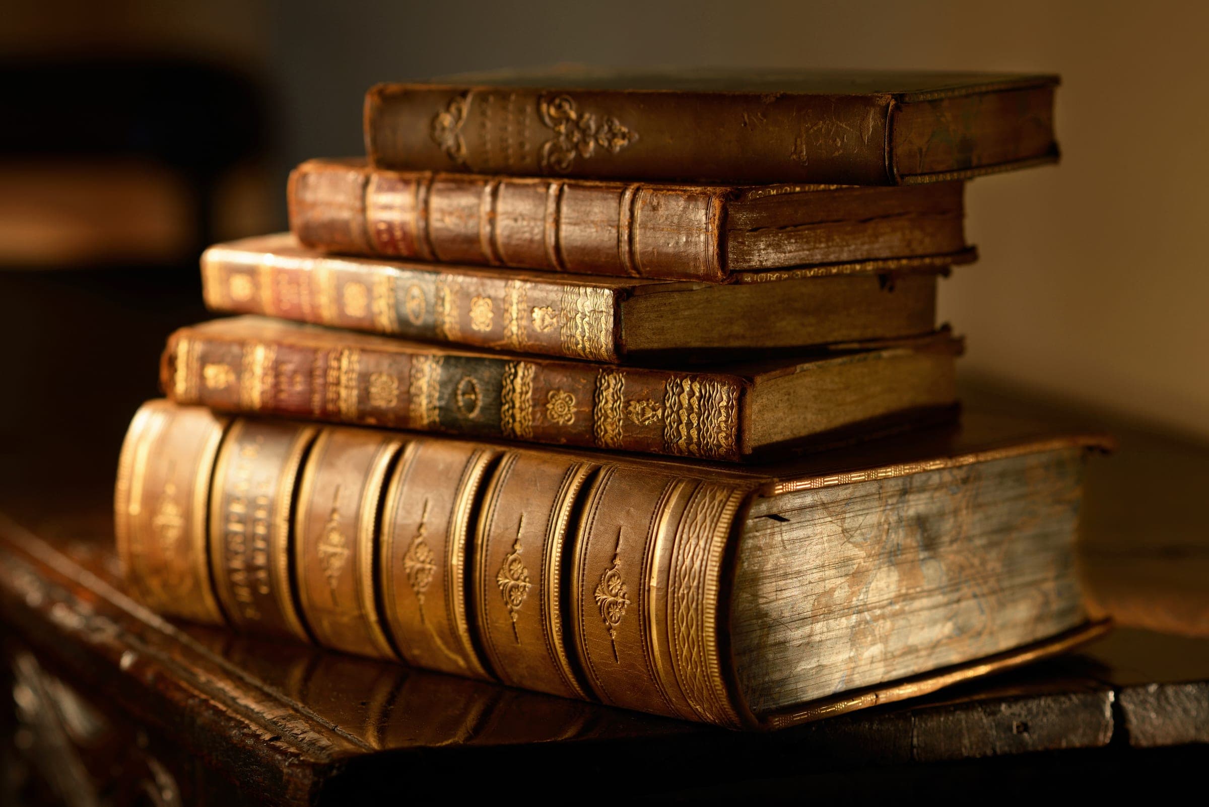 Antique leather-bound texts representing estate documents.
