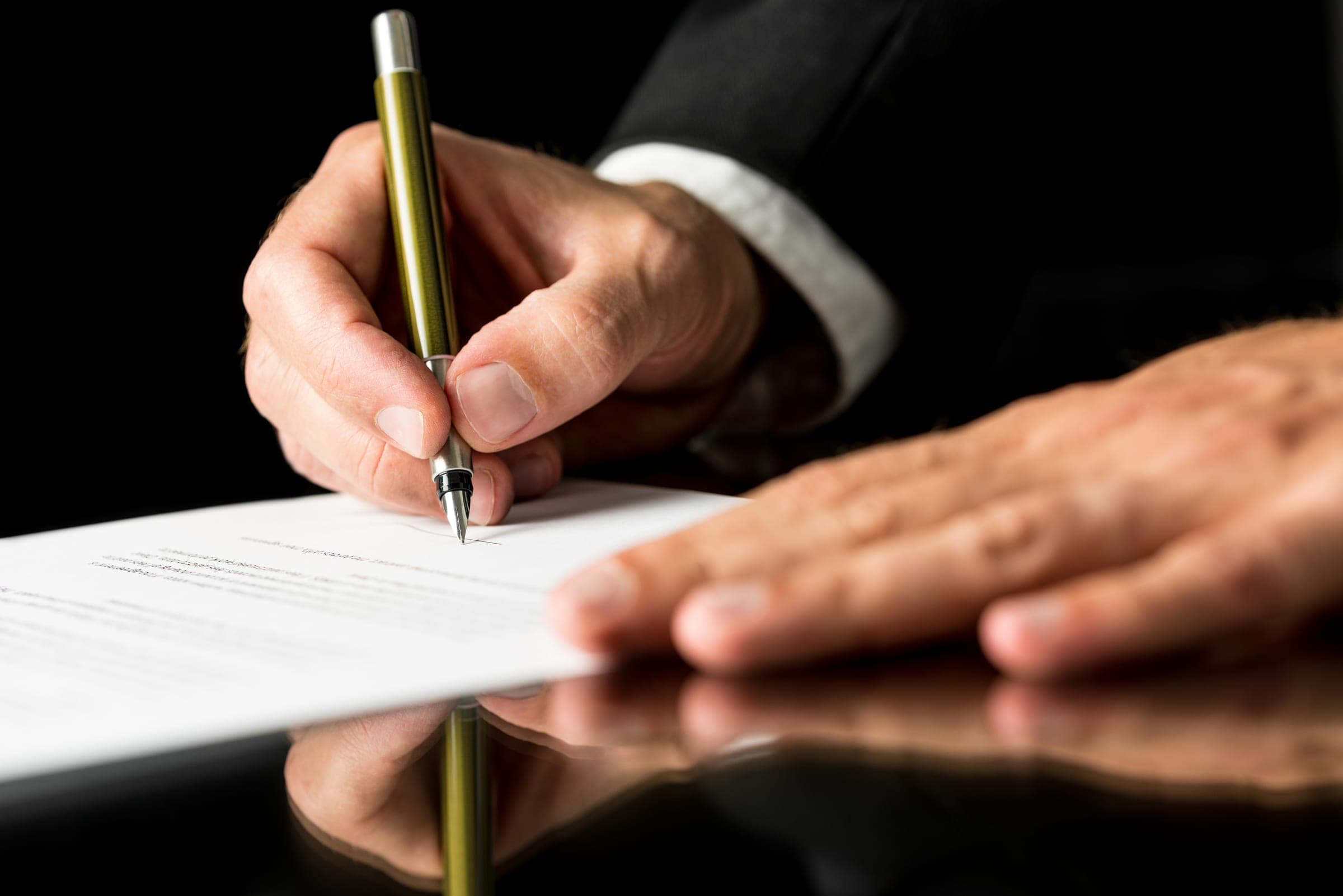 A lawyer signing a commercial contract.